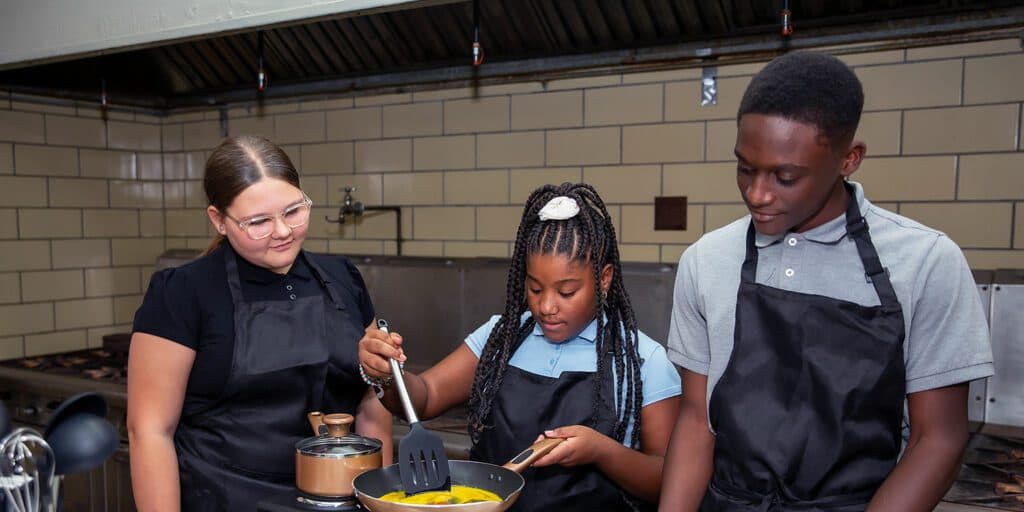Toledo Prep students preparing food together in the culinary classroom